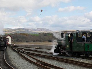 Merddin Emrys and Blanche, with a paraglider in the air between